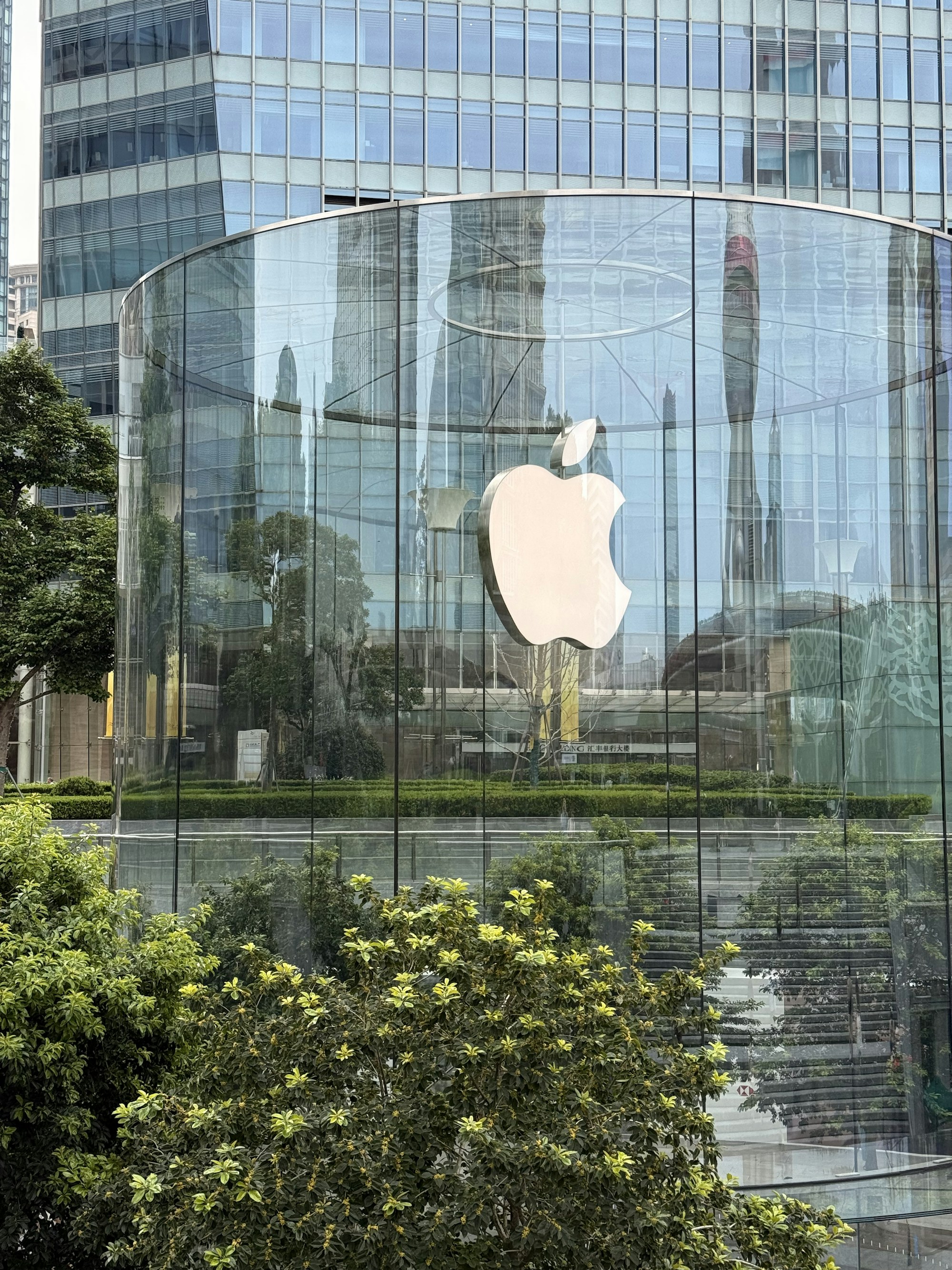 Apple Store in Shanghai with a large illuminated Apple logo, used as an editorial photograph for the iPhone Duo announcement.