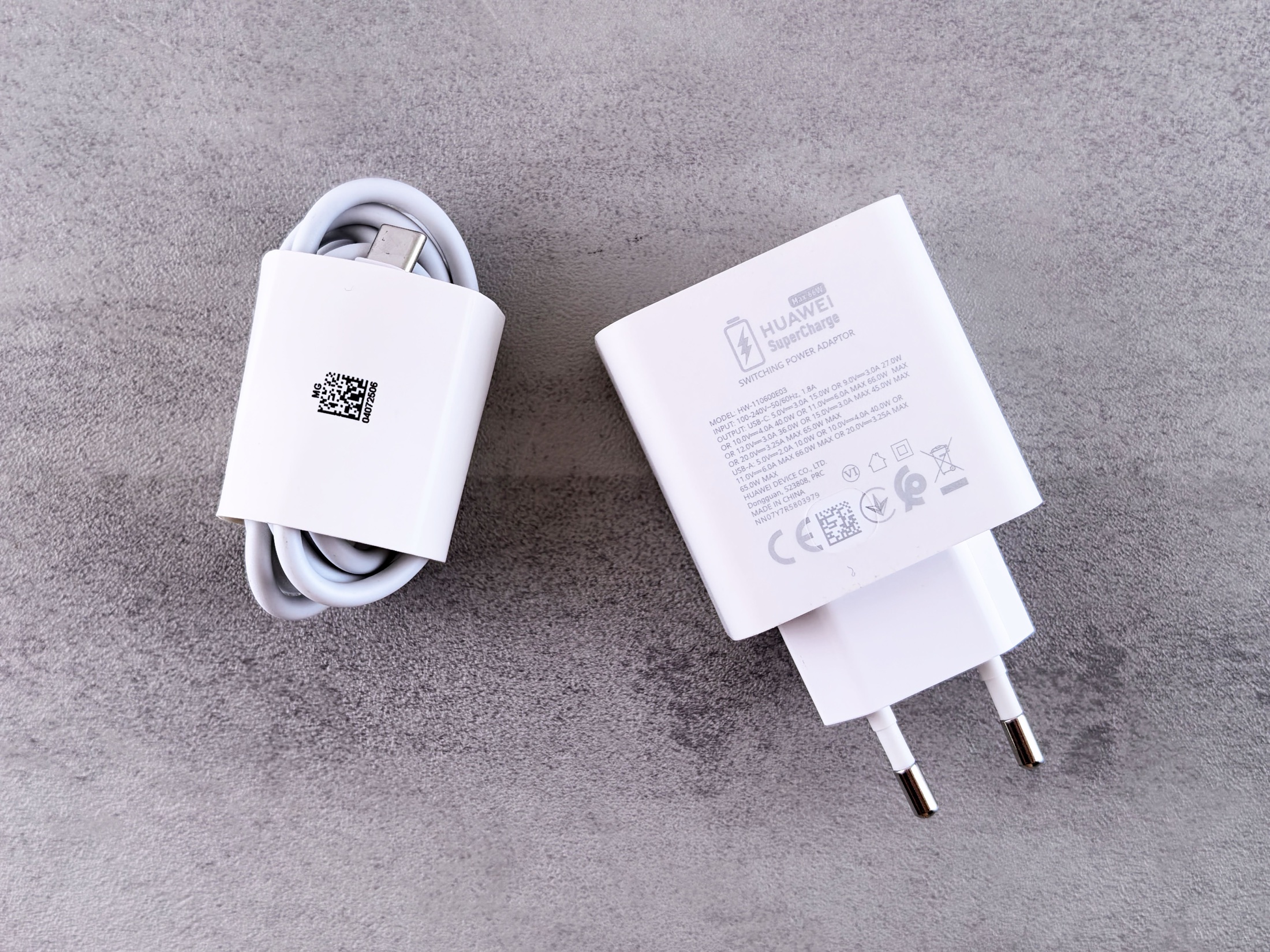 White USB phone charger and cable photographed on a grey surface, used as a generic editorial illustration.