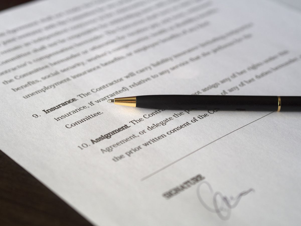 Close-up of a contract and pen used as an editorial illustration for supplier identity checks.