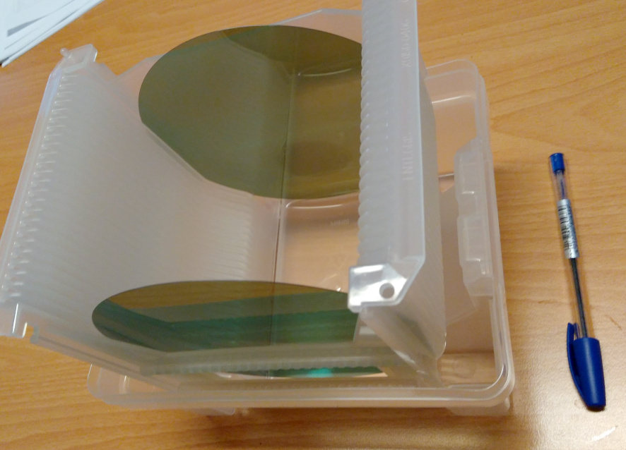 Two six-inch silicon-carbide wafers in a protective transport box.