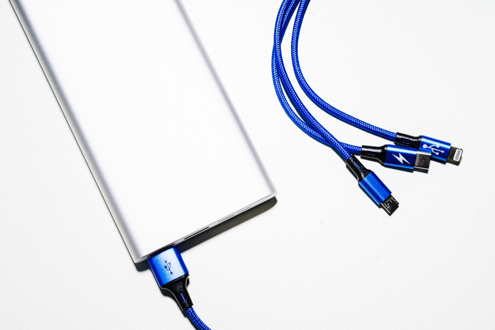 White power bank and cables used as an editorial illustration for UN 38.3 transport-document checks.