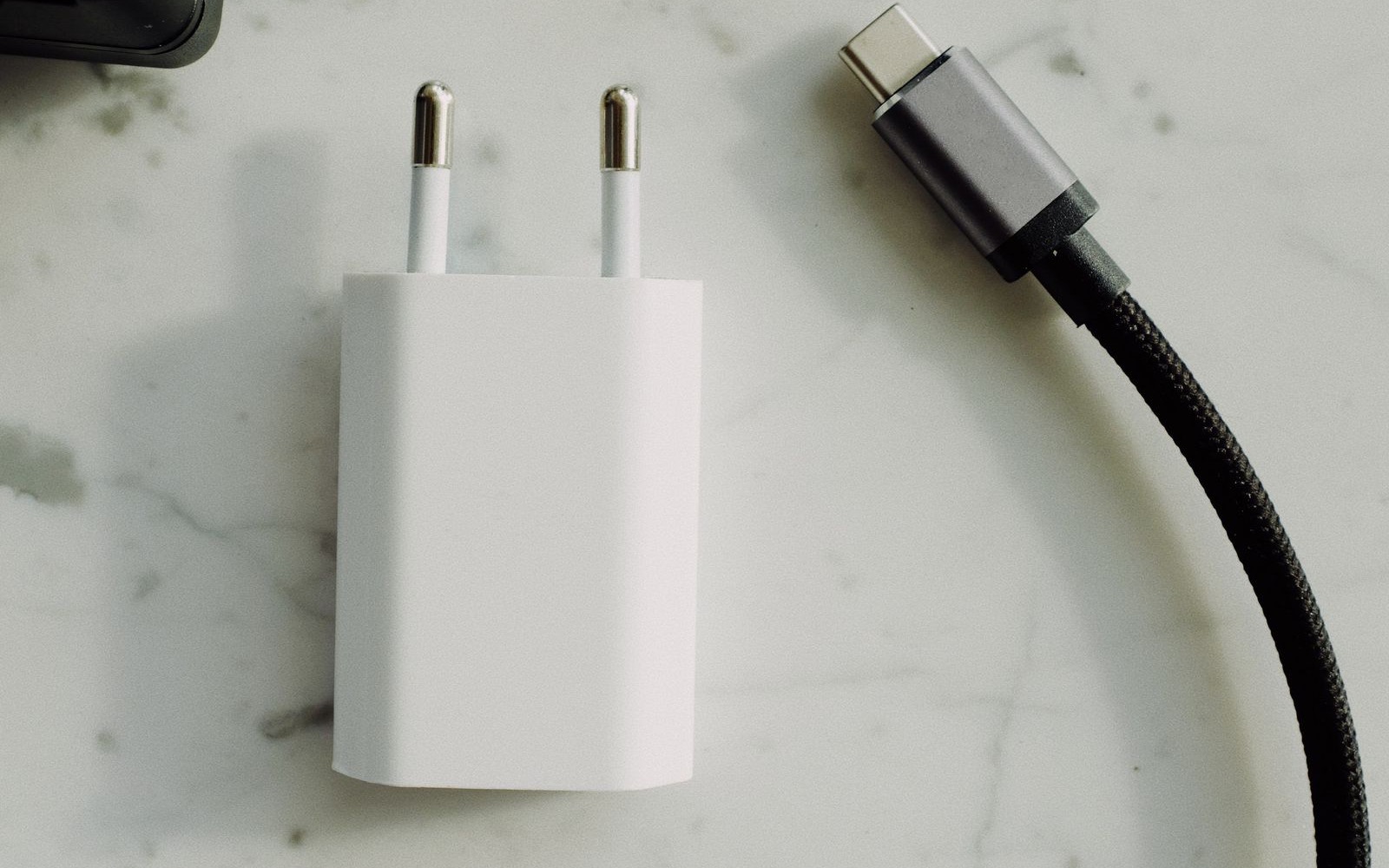 USB-C cable beside power adapters, used as an editorial illustration for USB-IF charger-record checks.